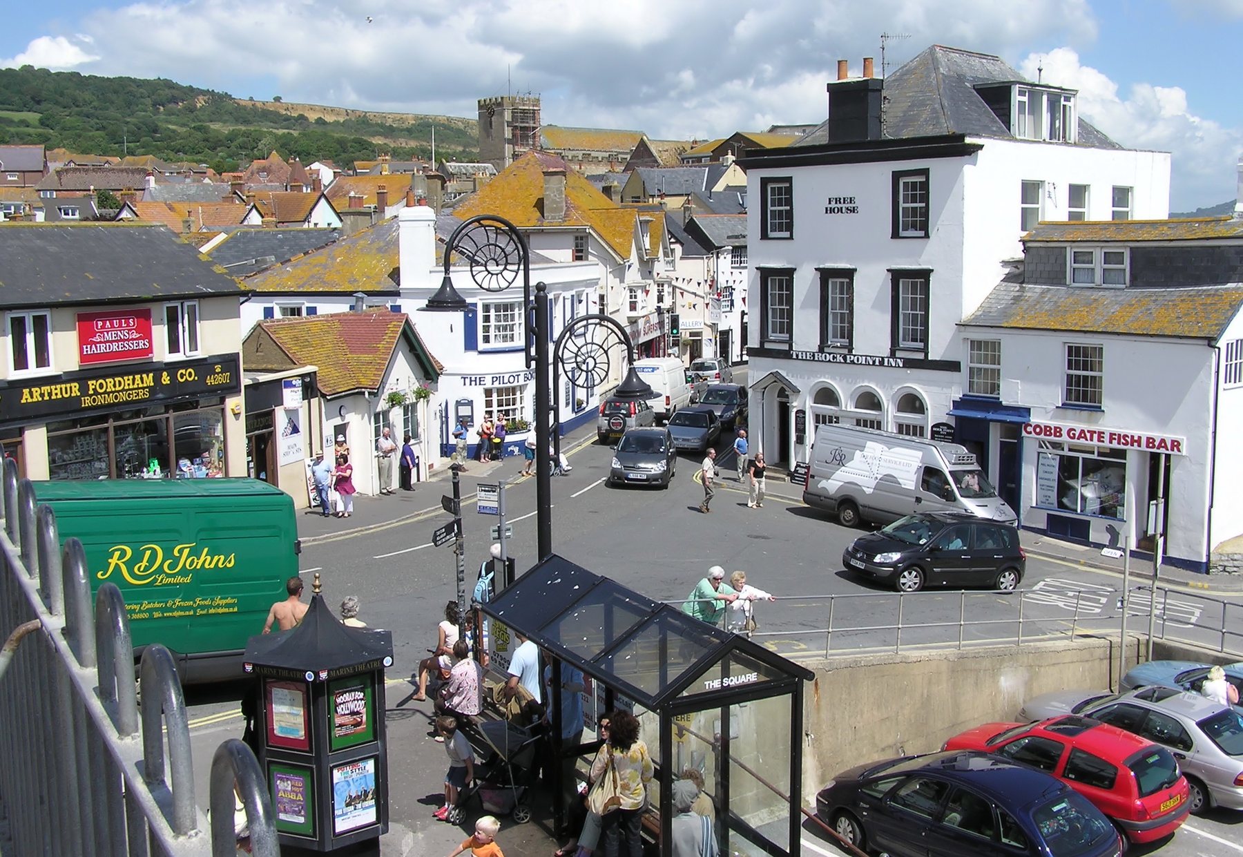 Lyme Regis town centre with historic buildings and ammonite-shaped street lamps